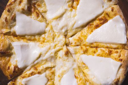 Mengrel khachapuri closeup on a wooden tray. Georgian national traditional cuisineの写真素材