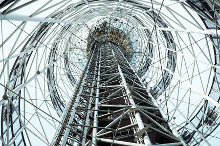Light metal architectural form. High tower with spiral structures inside view. Futuristic...