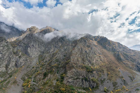 Mountain landscape panorama. A beautiful gorge on a sunny day, bright blue sky with fluffy white clouds.の写真素材