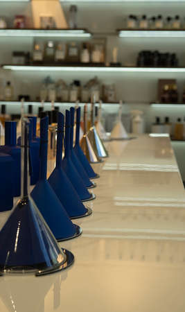 Perfume bottles and funnels with fragrance on the counter in a luxury store. cosmetic products exhibition saleの写真素材