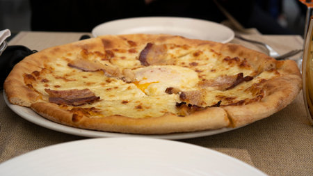 Original Italian Tasty appetizing pizza with ham and cheese close-up. traditional italian foodの写真素材