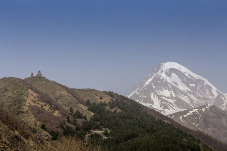 A breathtaking view of Mount Kazbek in Georgia, with its snow-capped peak rising majestically under...