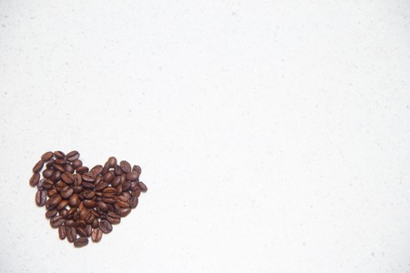 Spilled coffee beans. Coffee in the form of hearts.の写真素材