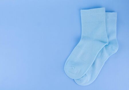 Blue socks on a blue background. Socks on a colored backgroundの写真素材