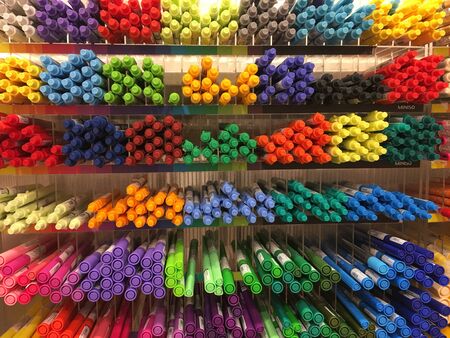 A lot of markers are on the shelf in the store. Color spectrum of markers. Lots of colored markers. Photo Verticalの写真素材