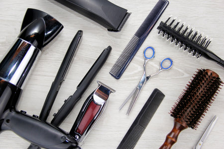 Full frame of professional hair dresser tools on black background