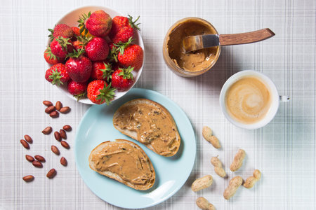 Breakfast with milk, whole grain rolls, butter and jamの写真素材