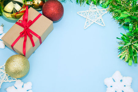 Gift and Christmas decorations on a blue background. Gift box with red ribbon