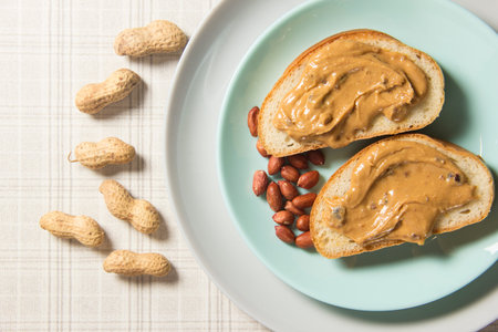 Two slice of peanut butter sandwich on a plate