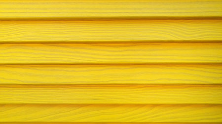 Yellow painted wood. Wooden slats of yellow color. The texture of the treeの写真素材
