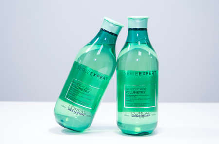 Russia, Kemerovo 01.02.2021. Loreal Professional hair cosmetics. Close-up of a bottle of shampoo in a hair salon. Shampoo in a green bottle.のeditorial素材
