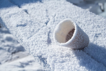People who are frozen on the street drink coffee and tea. Frozen drink on the street in winter. Ice...