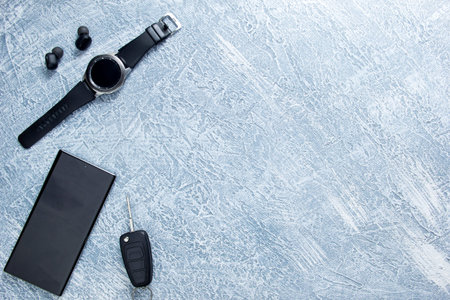 Men's watches, glasses, smartphone, accessories. Black accessories on a gray background.の写真素材