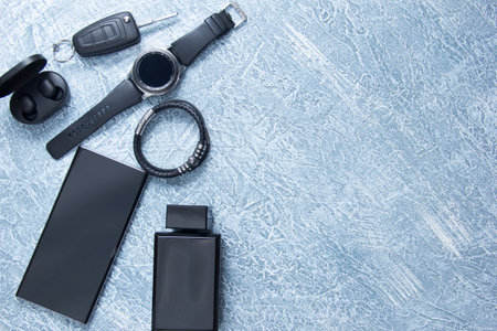 Men's watches, glasses, smartphone, accessories. Black accessories on a gray background.の写真素材
