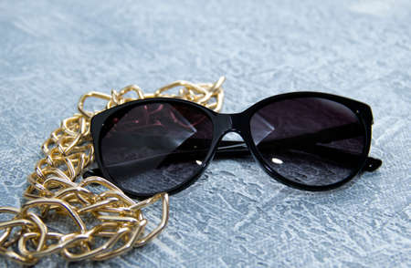 Womens sunglasses on a gray background. Free space for text.の写真素材