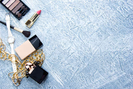 Womens accessories and cosmetics. Still life of fashionable women. Scattered accessories: nail polish, perfume, lipstick, foundation. Top viewの写真素材