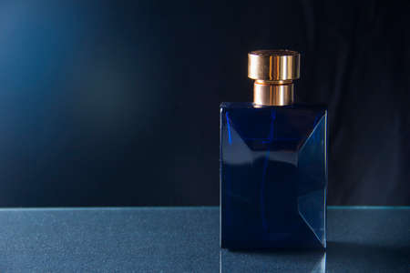 pink and blue perfume bottle with reflection on black backgroundの写真素材