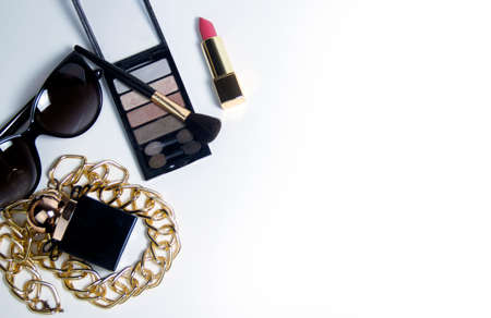 Womens accessories in black and cosmetics on a white background. Top view of the desktop for womenの写真素材