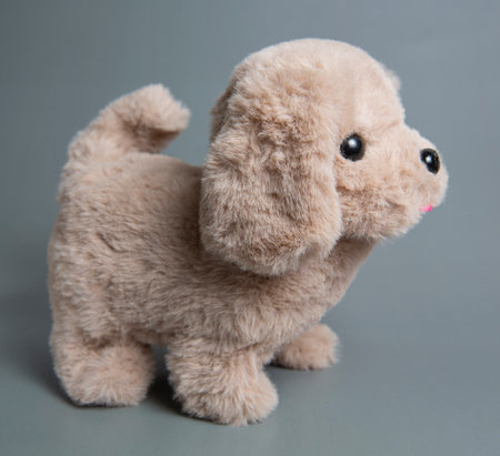A stuffed dog toy. Cute toy puppy shot on a gray backgroundの写真素材