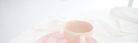 Tender pink mug on light background. Ceramic coffee cup for montage or design.の写真素材