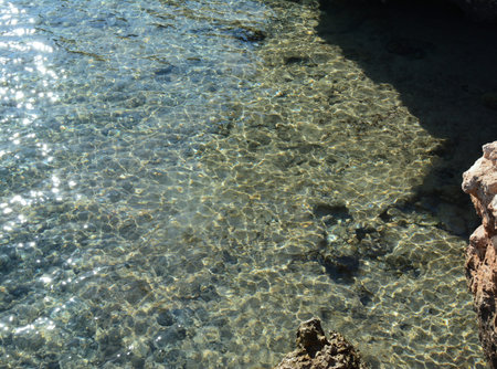 Sea stones in clean sea water. Abstract nautical background.