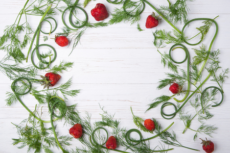 Strawberries and greens on white background. Copy spaceの写真素材