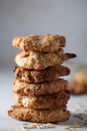 A stack of homemade oatmeal cookies on a grey background.の写真素材