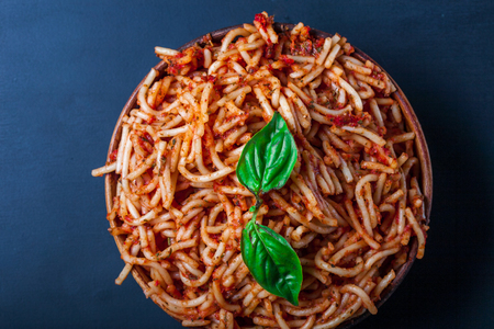 Italian spaghetti with a bolognese tomato meat sauce and basil in a plate. Copy space. Italian food concept.の写真素材