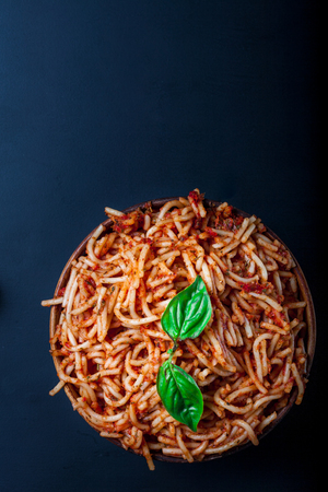 Italian spaghetti with a bolognese tomato meat sauce and basil in a plate. Copy space. Italian food concept.の写真素材