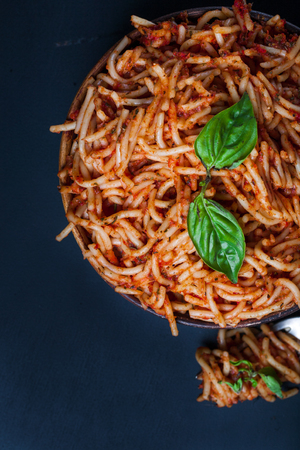 Italian spaghetti with a bolognese tomato meat sauce and basil in a plate. Copy space. Italian food concept.の写真素材