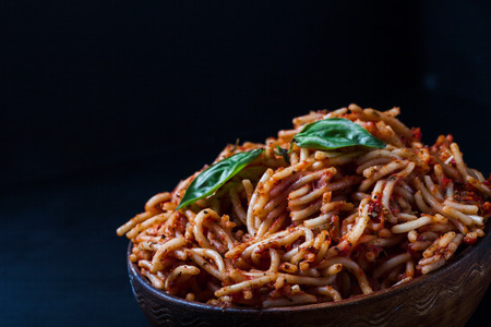 Italian spaghetti with a bolognese tomato meat sauce and basil in a plate. Copy space. Italian food concept.の写真素材