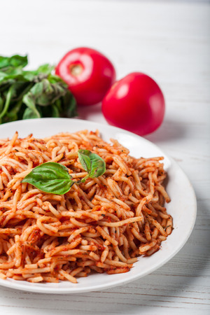 Italian spaghetti with a bolognese tomato meat sauce and basil in a plate. Copy space. Italian food concept.の写真素材