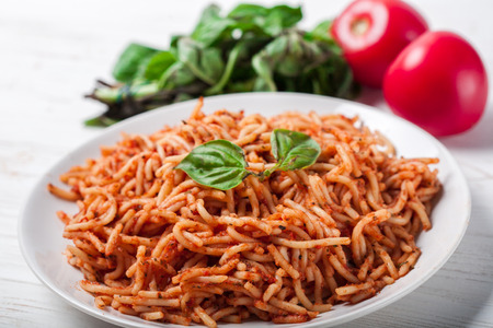 Italian spaghetti with a bolognese tomato meat sauce and basil in a plate. Copy space. Italian food concept.の写真素材