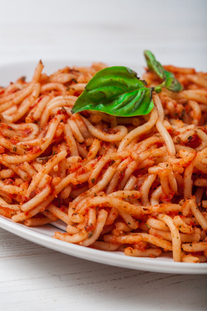 Italian spaghetti with a bolognese tomato meat sauce and basil in a plate. Copy space. Italian food concept.の写真素材