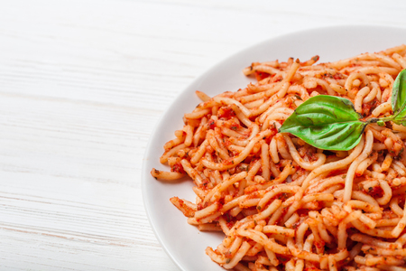 Italian spaghetti with a bolognese tomato meat sauce and basil in a plate. Copy space. Italian food concept.の写真素材