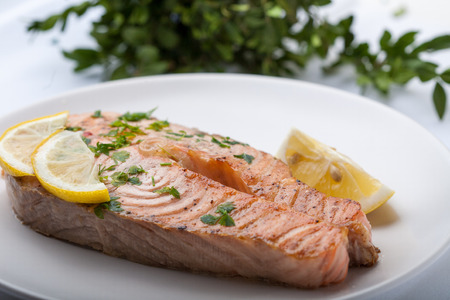 Fish with lemon on a grillの写真素材