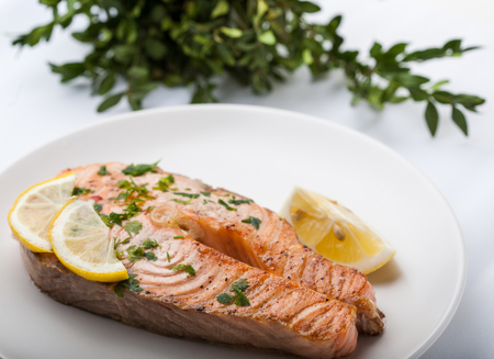 Fish with lemon on a grillの写真素材