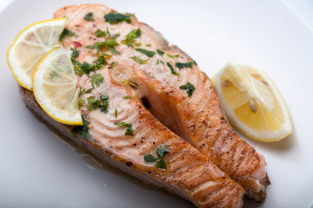 Fish with lemon on a grillの写真素材