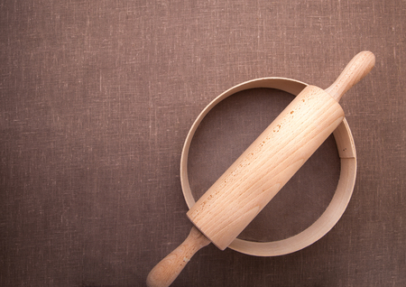 Baking ingredients. Flour, eggs, wheat and rolling pin on  table cloth. Rustic.の写真素材