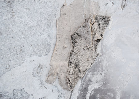 Dusty peeling paint wall background, texture of a concrete old wall with stains and cracksの写真素材