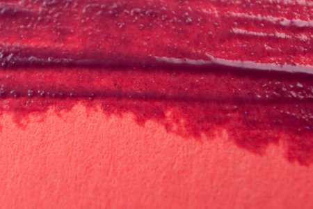 Lipstick smear on a red background. Close-up.の写真素材
