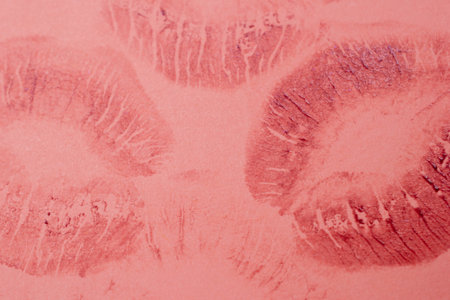 Lipstick kiss on pink background. Closeup of female lips.の写真素材