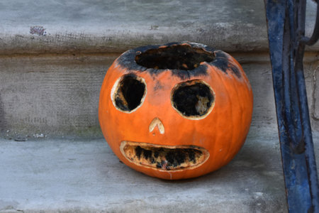 Halloween pumpkin with scary face and mouth on stone stairs background.の写真素材