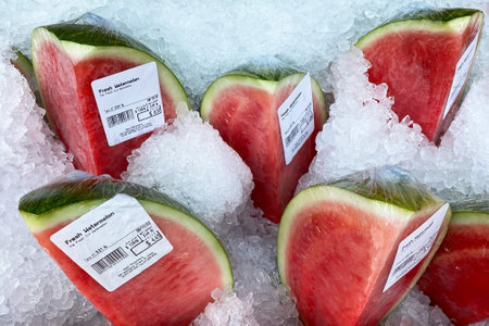 Watermelons on ice in a supermarket, closeup of photoの写真素材