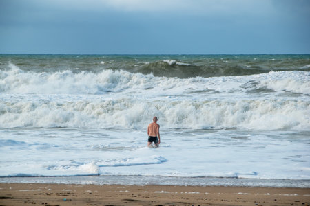 Surfer in the sea on a stormy day. Winter.の写真素材