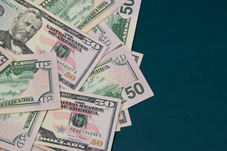 American dollar banknotes on a dark blue background with copy space.の写真素材