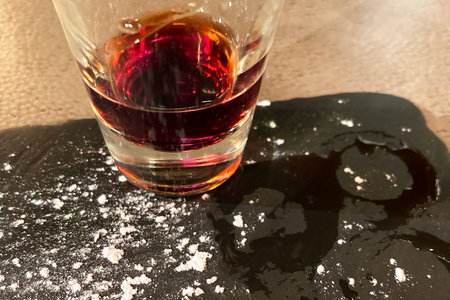 close up of a glass of cognac on a table in a restaurant
