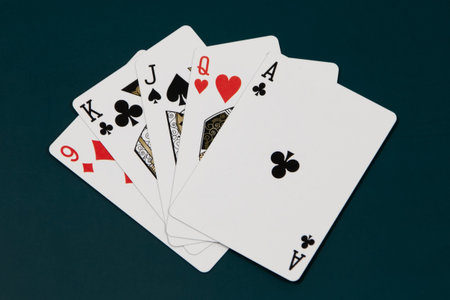 Playing cards on a dark green background, top view, copy spaceの写真素材