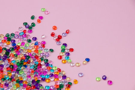 Colorful beads on pink background, top view. Copy space.の写真素材