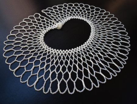 Handmade crochet doily on a black background. Selective focus.
